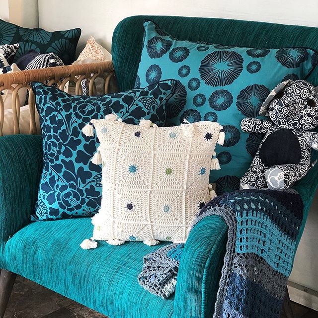 Lovely cool toned cushions make for an inviting armchair.